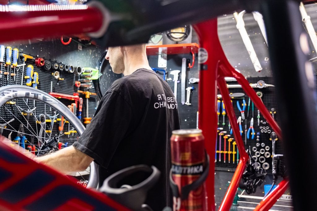 a-man-working-on-a-bike-in-a-garage-cwl7xp7hsjm
